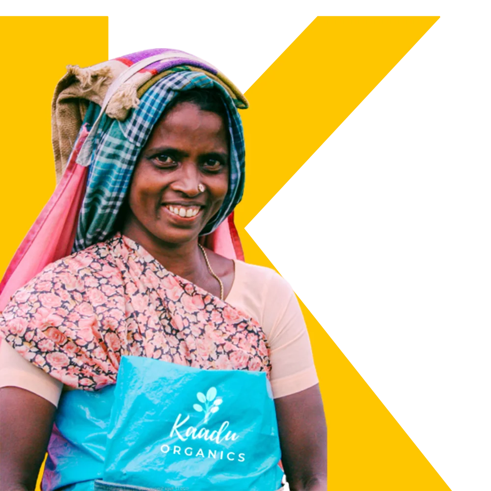 Smiling woman farmer standing in a lush green field, symbolizing joy and dedication to organic farming